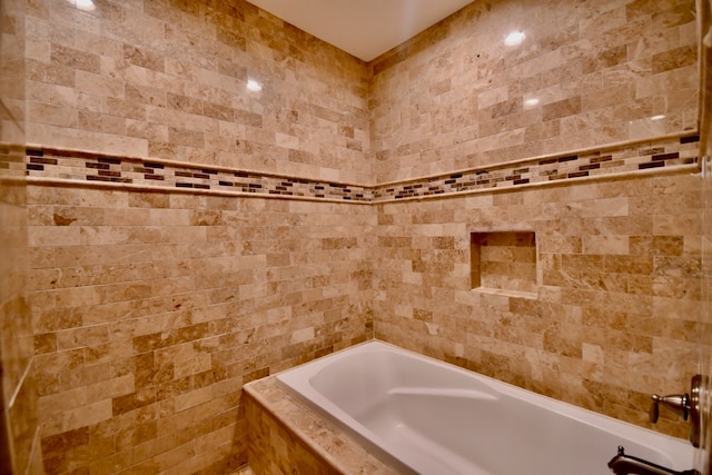 bathroom featuring a relaxing tiled tub