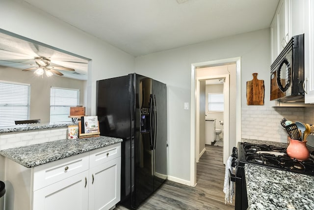 kitchen with backsplash, dark wood-type flooring, black appliances, stone counters, and white cabinets