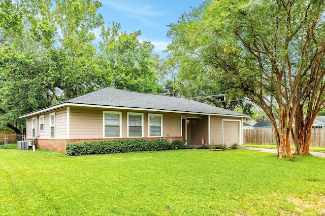 single story home featuring a garage, central AC, and a front lawn