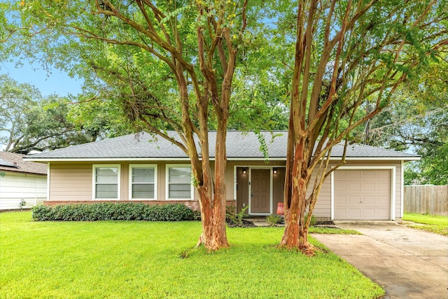 ranch-style house featuring a garage and a front lawn