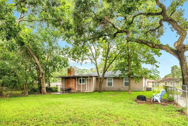 back of house with a yard