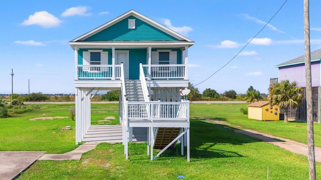 view of play area with covered porch, a shed, and a lawn