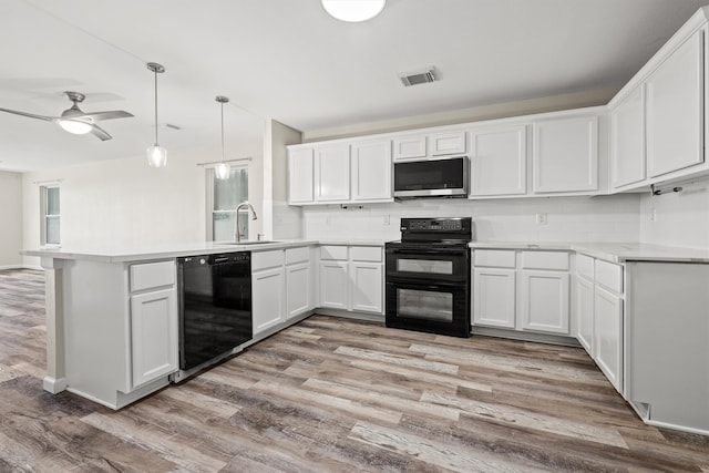 kitchen featuring black appliances, pendant lighting, white cabinets, and kitchen peninsula