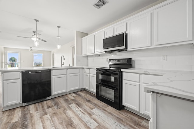 kitchen featuring black appliances, sink, decorative backsplash, light wood-type flooring, and white cabinetry