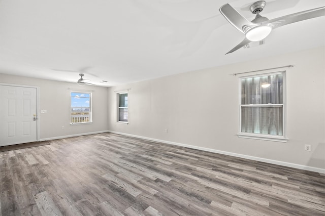 empty room featuring wood-type flooring and ceiling fan