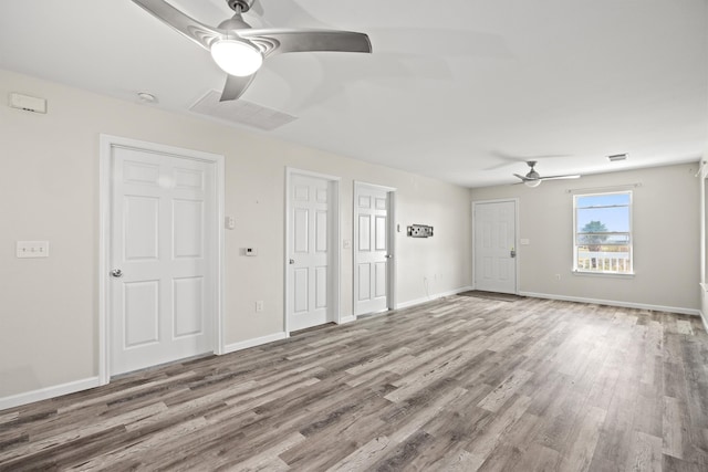 unfurnished living room with ceiling fan and hardwood / wood-style flooring