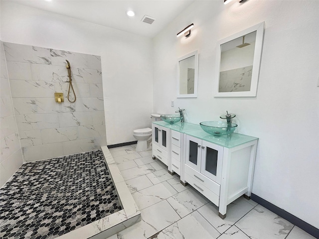 bathroom with a shower, vanity, and toilet