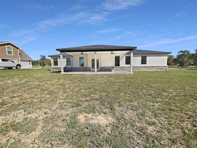 back of house featuring a patio, ceiling fan, and a lawn