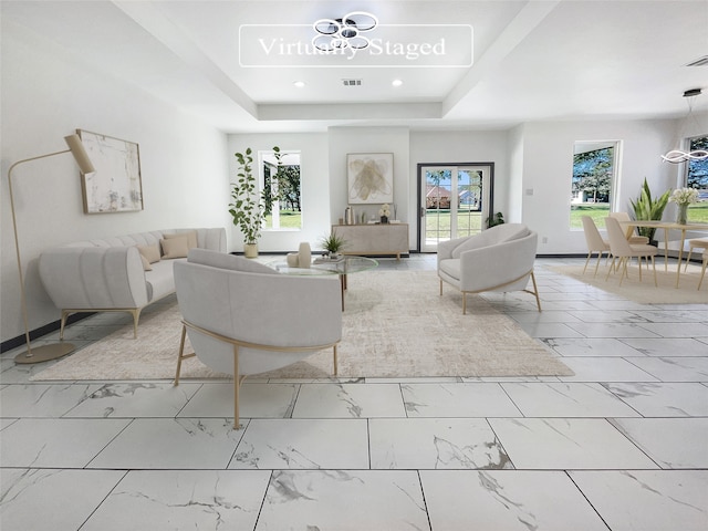 living room featuring a tray ceiling