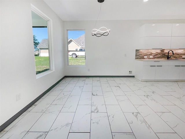 unfurnished dining area featuring sink