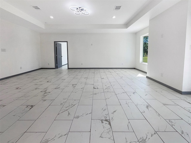 spare room featuring a tray ceiling