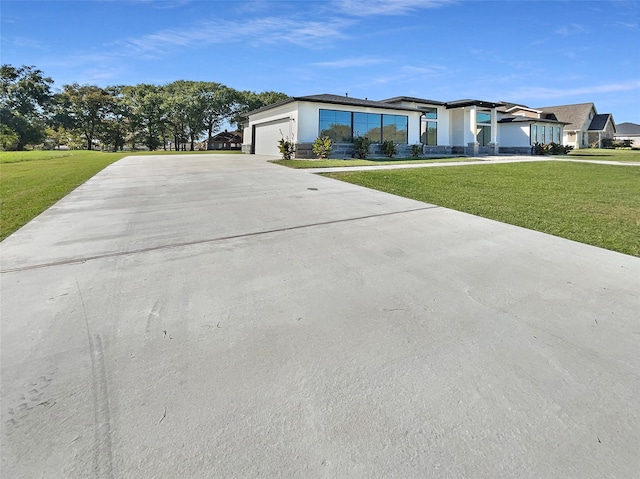 view of front of home with a garage and a front lawn