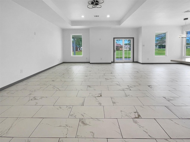 145 Birdie Dr, Hempstead, TX 77445 - empty room featuring a raised ceiling, baseboards, light marble finish flooring, and recessed lighting