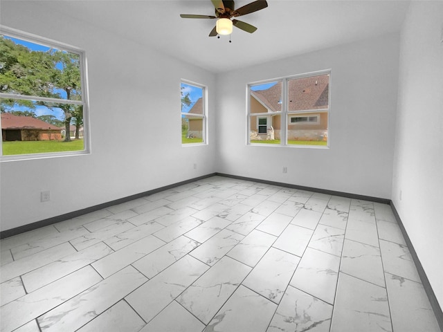 145 Birdie Dr, Hempstead, TX 77445 - unfurnished room with light marble finish flooring, baseboards, a ceiling fan, and healthy amount of natural light
