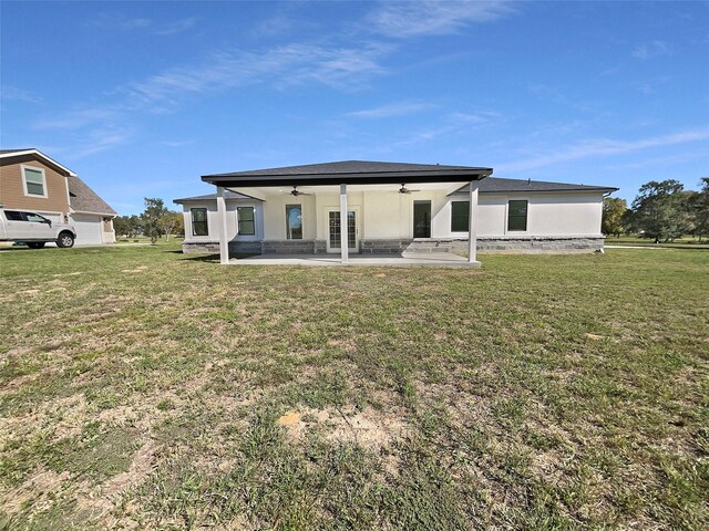 145 Birdie Dr, Hempstead, TX 77445 - rear view of house featuring ceiling fan, a patio area, a lawn, and stucco siding