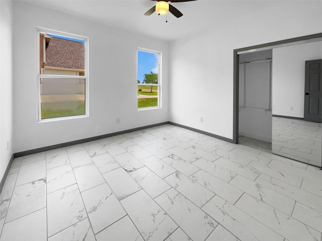145 Birdie Dr, Hempstead, TX 77445 - unfurnished bedroom featuring marble finish flooring, baseboards, a ceiling fan, and a closet