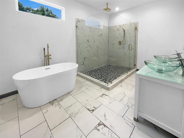 145 Birdie Dr, Hempstead, TX 77445 - full bathroom with marble finish floors, a marble finish shower, a soaking tub, and baseboards