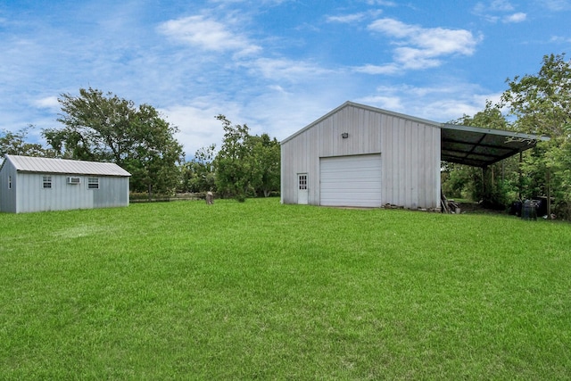 view of yard featuring a garage and an outdoor structure