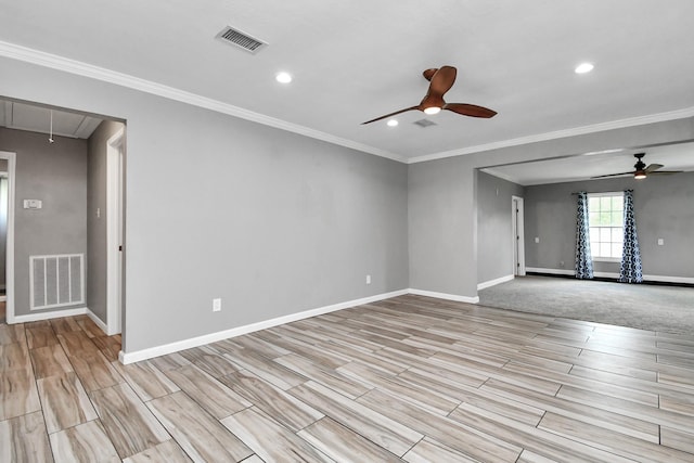 unfurnished room featuring ceiling fan and crown molding