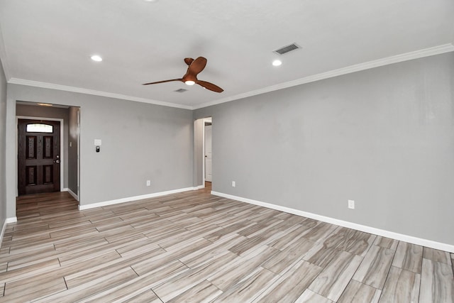 empty room featuring ceiling fan and ornamental molding