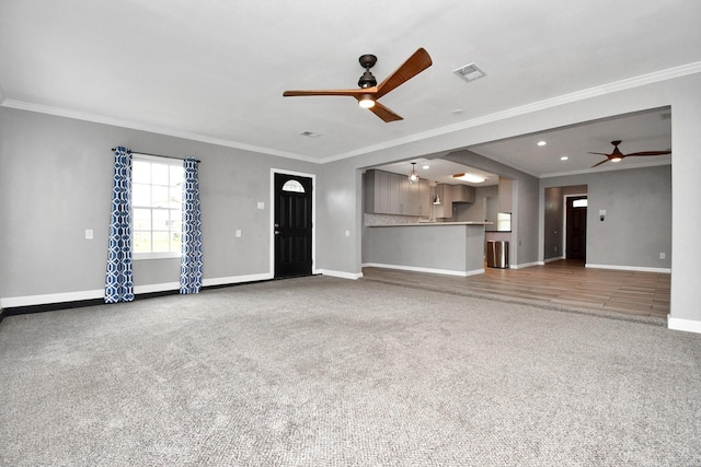 unfurnished living room featuring crown molding, carpet, and ceiling fan