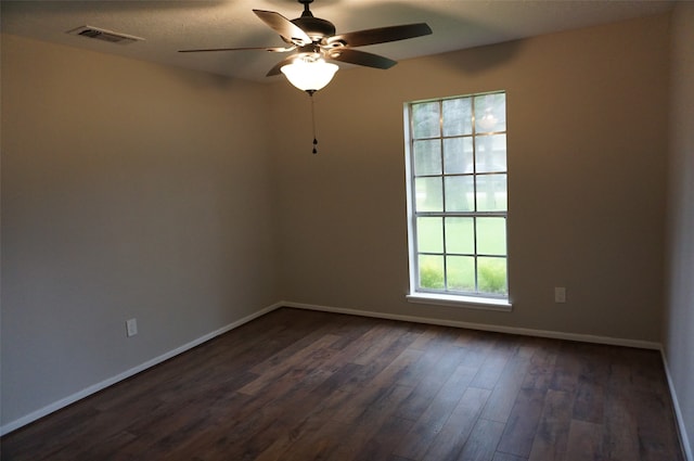 unfurnished room with dark hardwood / wood-style flooring and ceiling fan