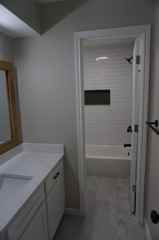 bathroom featuring vanity and tiled shower / bath combo