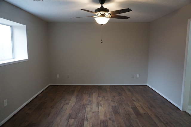 empty room featuring ceiling fan and dark hardwood / wood-style flooring