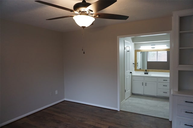 interior space featuring a textured ceiling, dark hardwood / wood-style flooring, ceiling fan, and sink