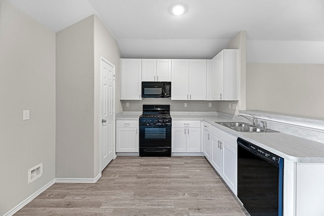 kitchen with white cabinets, light wood-type flooring, sink, and black appliances