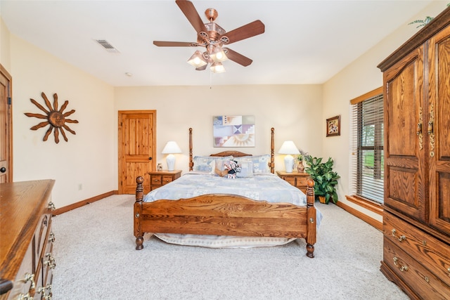 bedroom with ceiling fan and light carpet