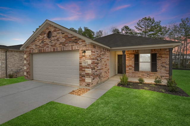 ranch-style house with a garage and a lawn