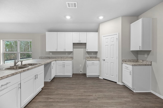 kitchen featuring white cabinetry, sink, and dark wood-type flooring