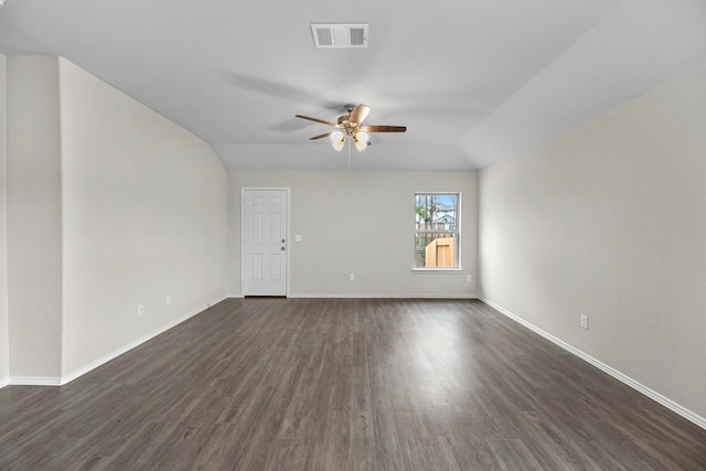 empty room featuring vaulted ceiling, ceiling fan, and dark wood-type flooring