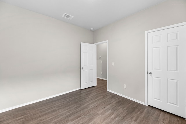 unfurnished bedroom with dark hardwood / wood-style floors