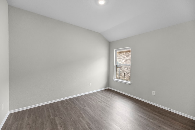 empty room featuring dark hardwood / wood-style floors and lofted ceiling