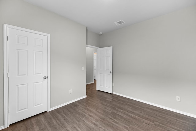 unfurnished bedroom with dark hardwood / wood-style floors