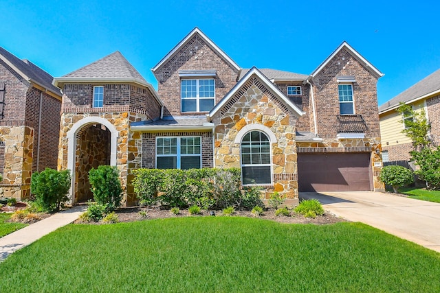 view of front of house with a garage and a front lawn