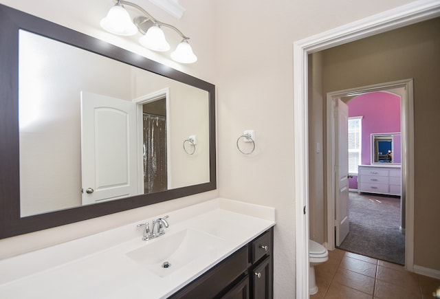 bathroom with tile patterned flooring, vanity, and toilet