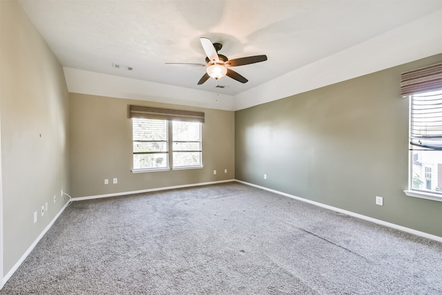 carpeted spare room featuring ceiling fan