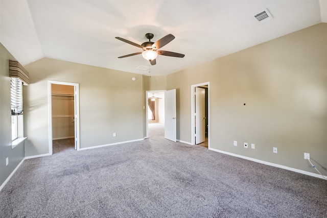 interior space featuring carpet, lofted ceiling, ceiling fan, a spacious closet, and a closet