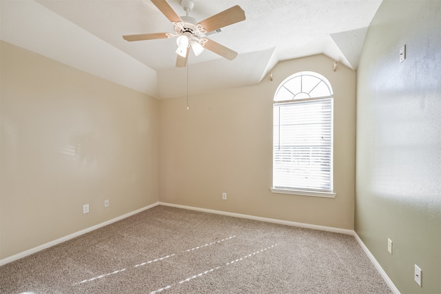 carpeted spare room featuring a textured ceiling, ceiling fan, and lofted ceiling