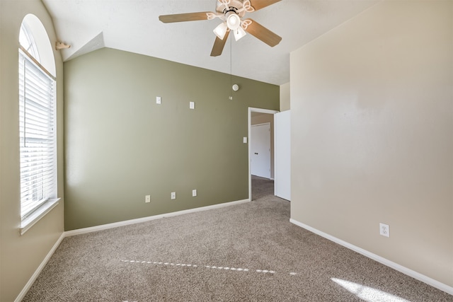 spare room featuring carpet flooring, ceiling fan, and lofted ceiling