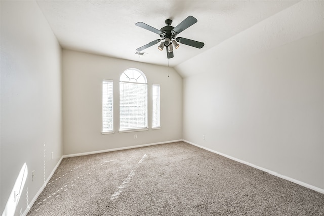 carpeted empty room featuring ceiling fan and lofted ceiling