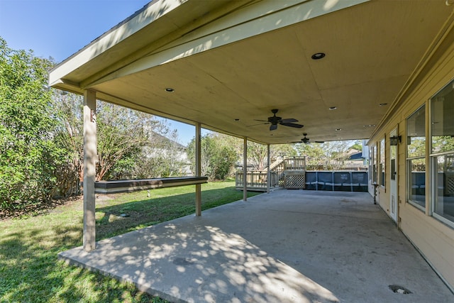 view of patio featuring a swimming pool side deck and ceiling fan