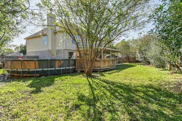 view of yard with a pool side deck