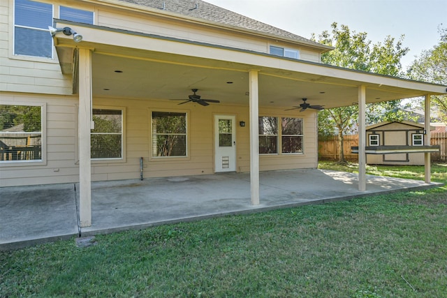 exterior space featuring a patio area, a yard, and a storage unit