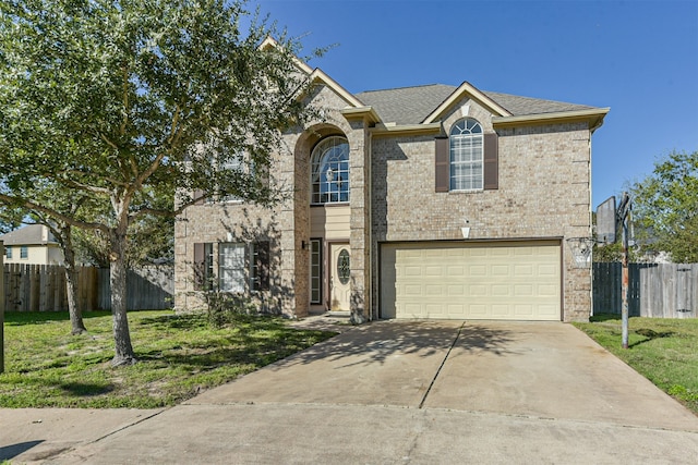 view of front of property featuring a garage and a front yard