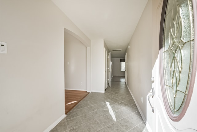 corridor featuring light tile patterned floors