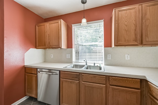 kitchen with dishwasher, dark tile patterned floors, hanging light fixtures, and sink